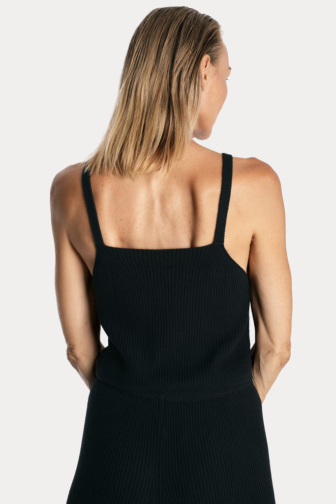 All natural zero waste knitted cotton pants in black with knitted tank top in black color back side closeup view.
