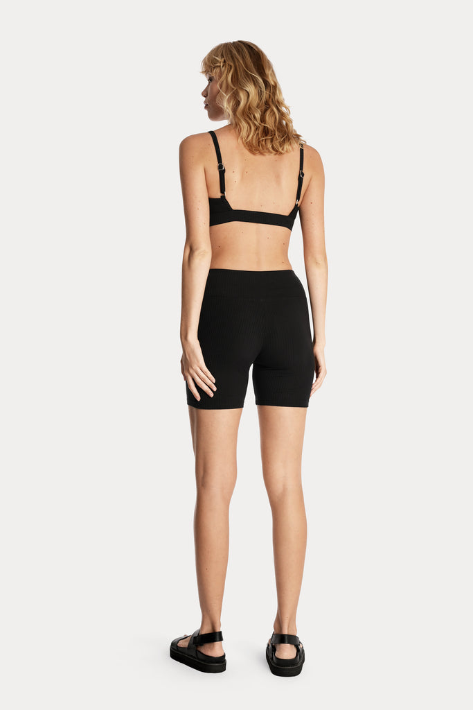 ECO RIB BIKER SHORTS | BLACK with ECO RIB BRALETTE | BLACK; back side full body view.