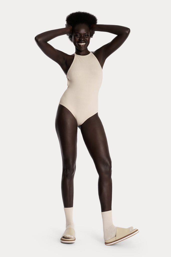 ECO RIB BODYSUIT | SAND; front side full body view.