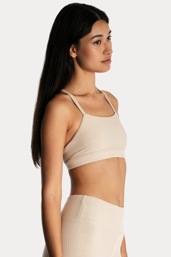 ECO RIB BRALETTE | SAND with ECO RIB STIRRUP LEGGINGS | SAND; right side closeup view.