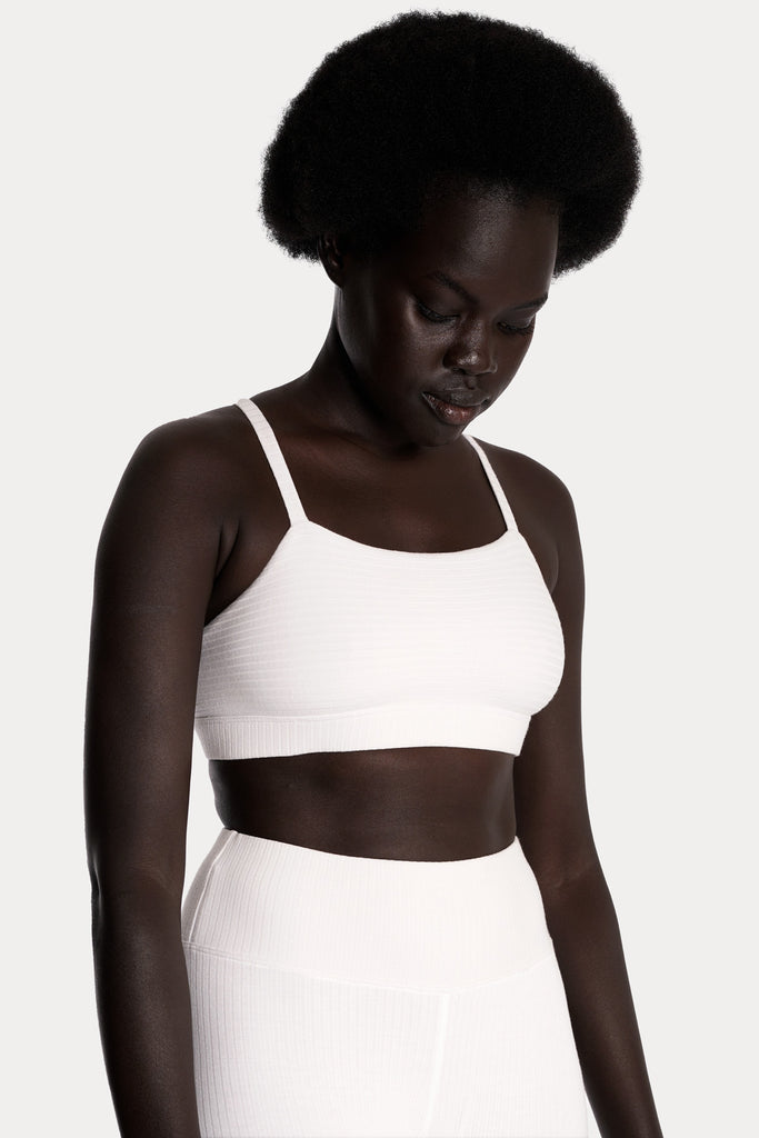 ECO RIB BRALETTE | WHITE with ECO RIB STIRRUP LEGGINGS | WHITE; front right side closeup view.