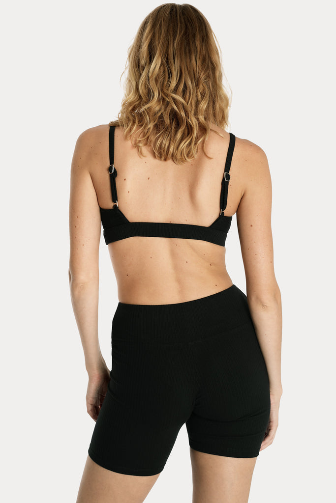 Lenzing ecovero eco rib jersey knit bralette in black with knit biker shorts in black back side closeup view.
