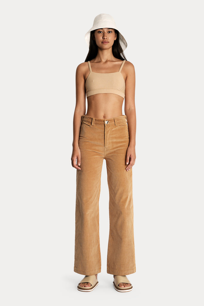 Lenzing ecovero eco rib jersey knit bralette in tan with Corduroy trousers in sandstone colour and white linen hat front side full body view.