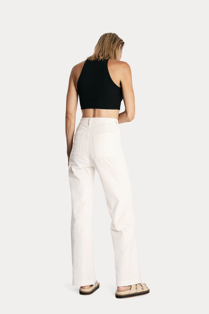 Lenzing ecovero eco rib jersey knit crop top in black with wide leg trousers in white colour back side full body view.