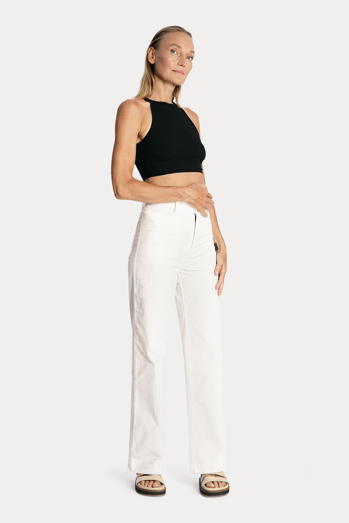Lenzing ecovero eco rib jersey knit crop top in black with wide leg trousers in white colour front right side full body view.