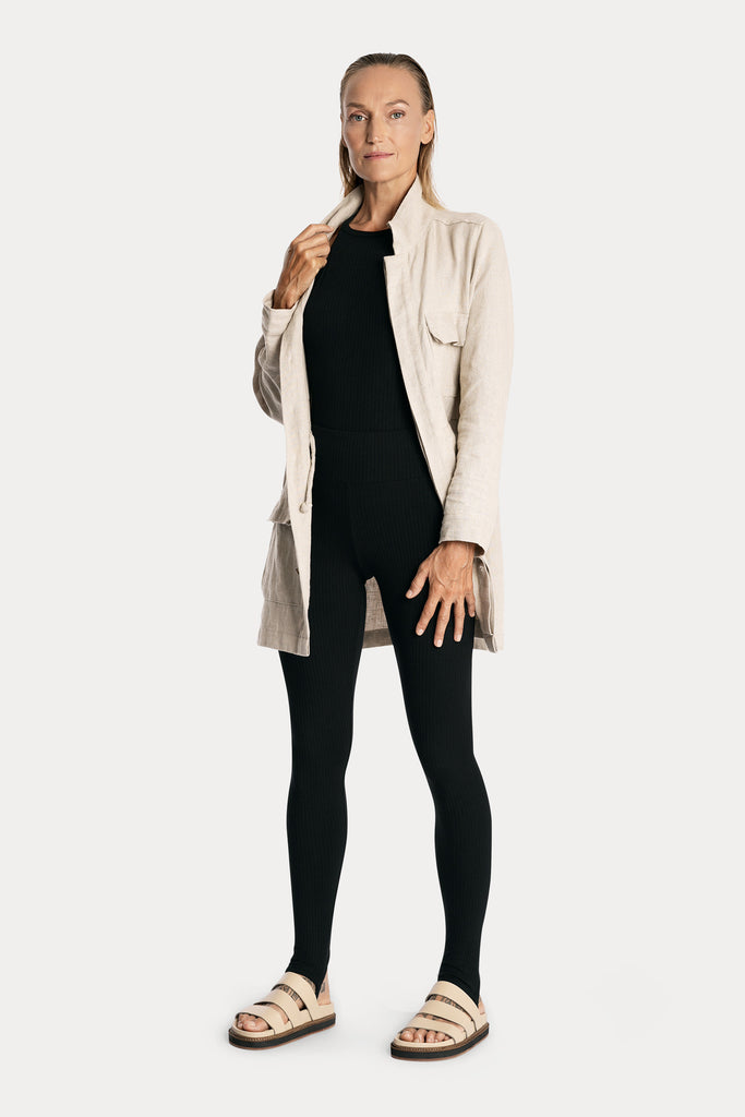 Lenzing ecovero eco rib jersey knit stirrup leggings in black with knit bodysuit in black and linen jacket in natural colour front side full body view.