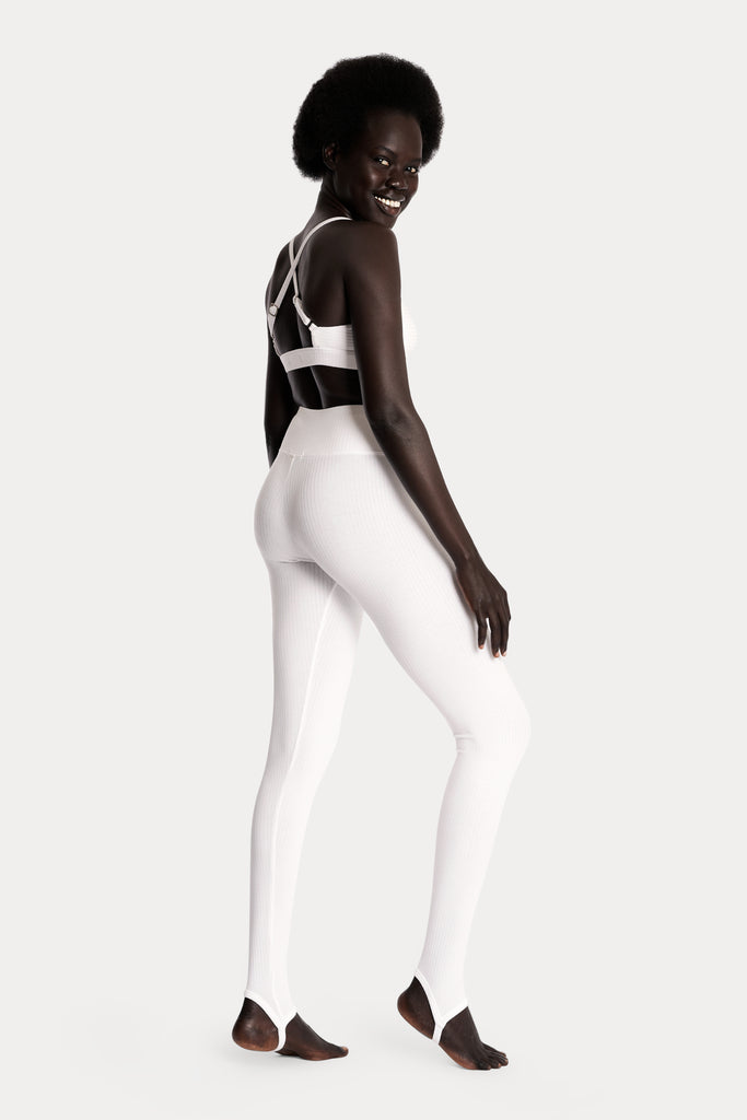 Lenzing ecovero eco rib jersey knit stirrup leggings in tan with knit crop top in white back right side full body view.