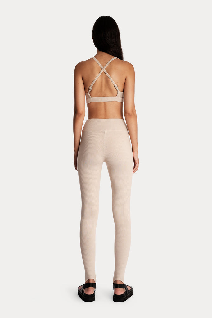 LENZING™ ECOVERO™ ECO RIB STIRRUP LEGGINGS | SAND with LENZING™ ECOVERO™ ECO RIB BRALETTE | SAND; back side full body view.